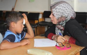 A social worker counsels a child in Gaza